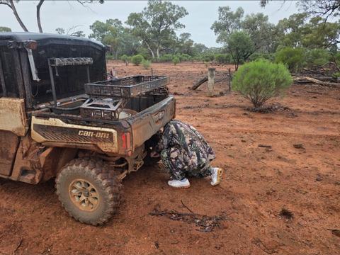 Checking the Can-Am in red dirt scrub country